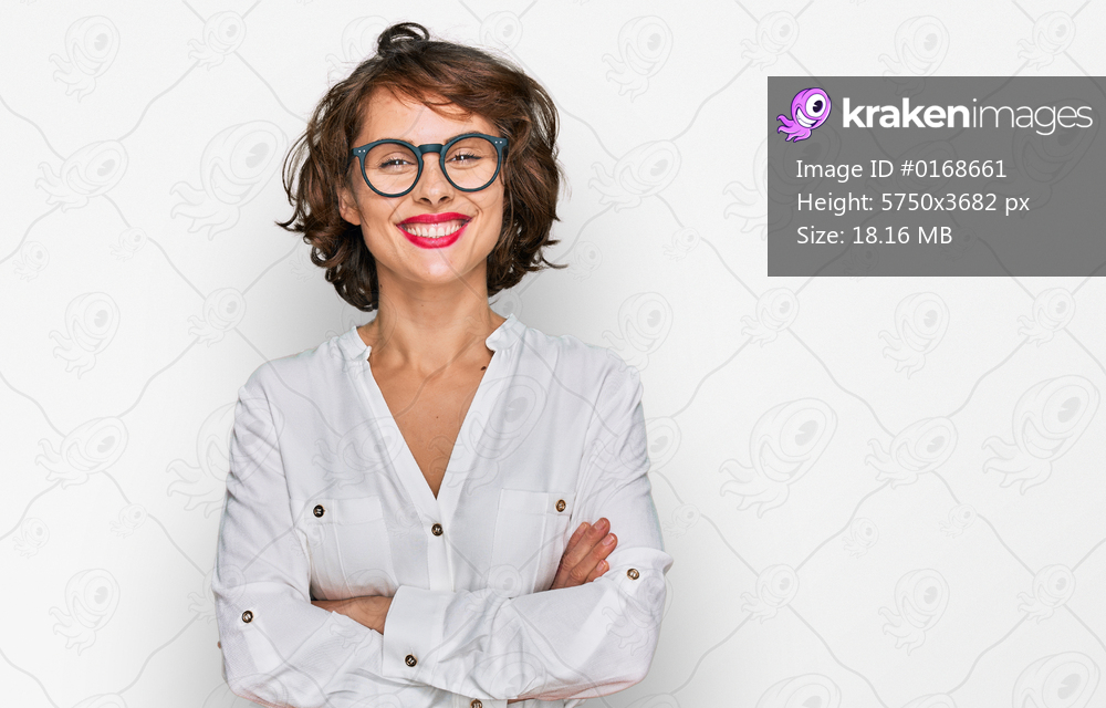 Young hispanic woman wearing business style and glasses happy face smiling with crossed arms looking at the camera. positive person. 