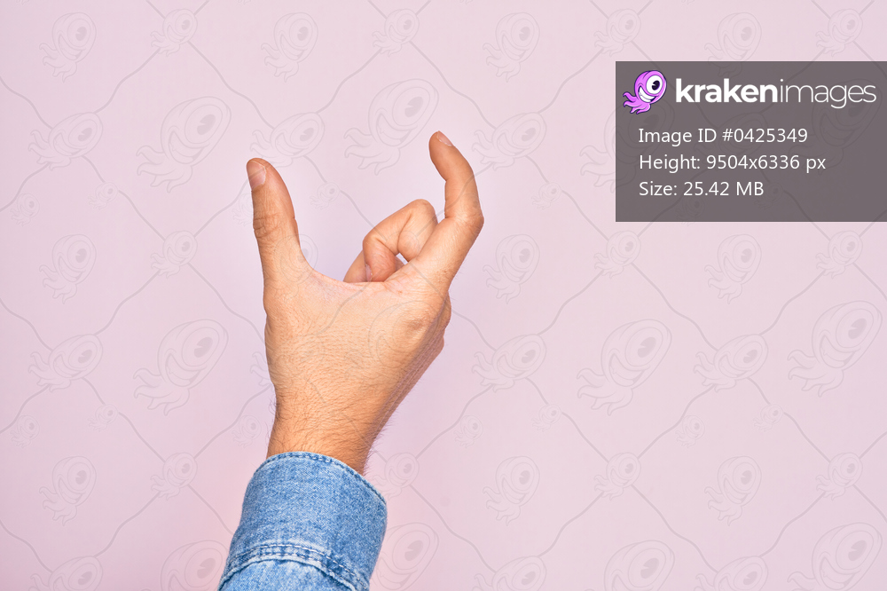 Hand of caucasian young man showing fingers over isolated pink background picking and taking invisible thing, holding object with fingers showing space