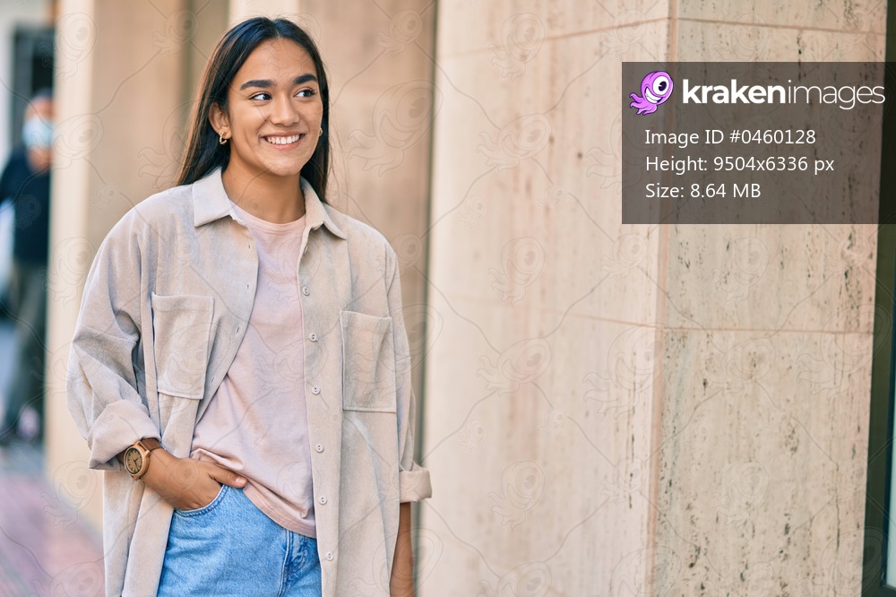 Young latin girl smiling happy standing at the city.
