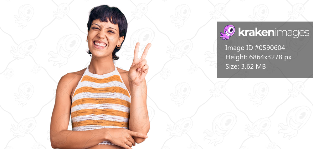 Young brunette woman with short hair wearing casual clothes smiling with happy face winking at the camera doing victory sign with fingers. number two. 