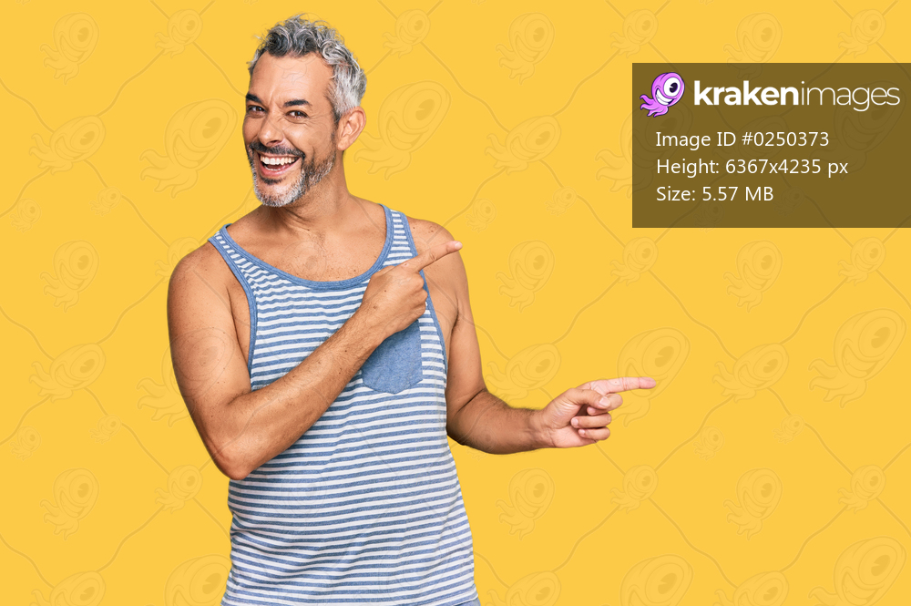 Middle age grey-haired man wearing casual style with sleeveless shirt smiling and looking at the camera pointing with two hands and fingers to the side. 