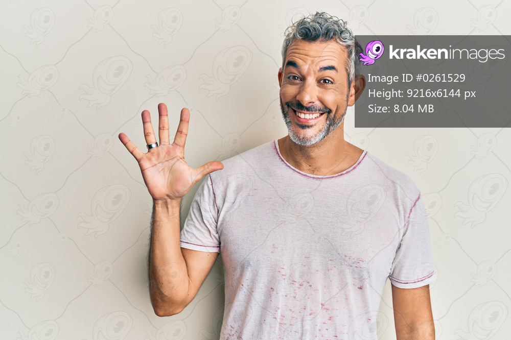 Middle age grey-haired man wearing casual clothes showing and pointing up with fingers number five while smiling confident and happy. 
