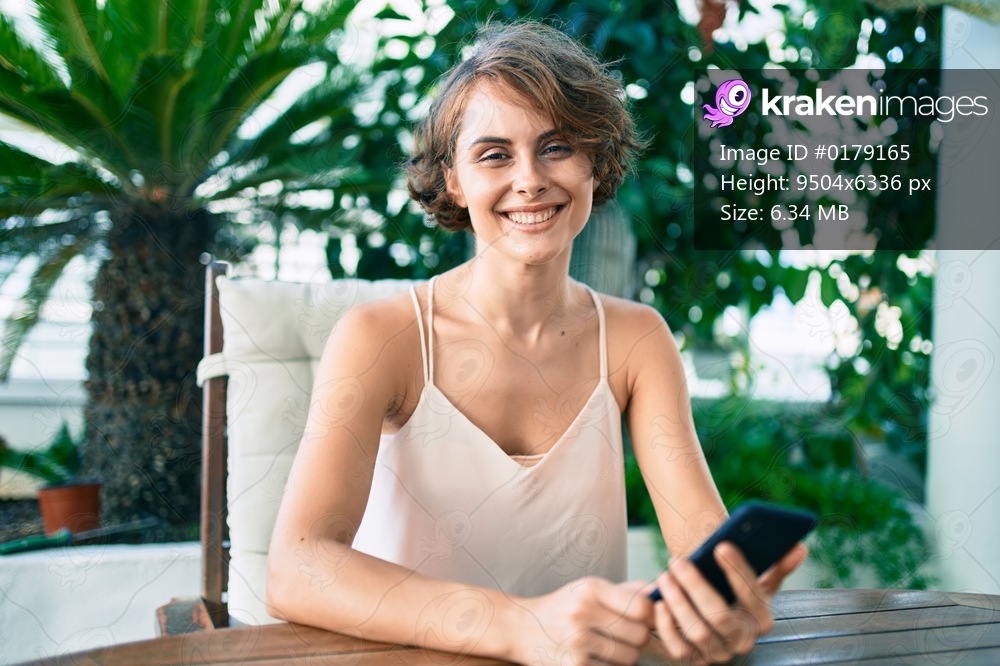 Young beautiful caucasian woman smiling happy using smartphone at home