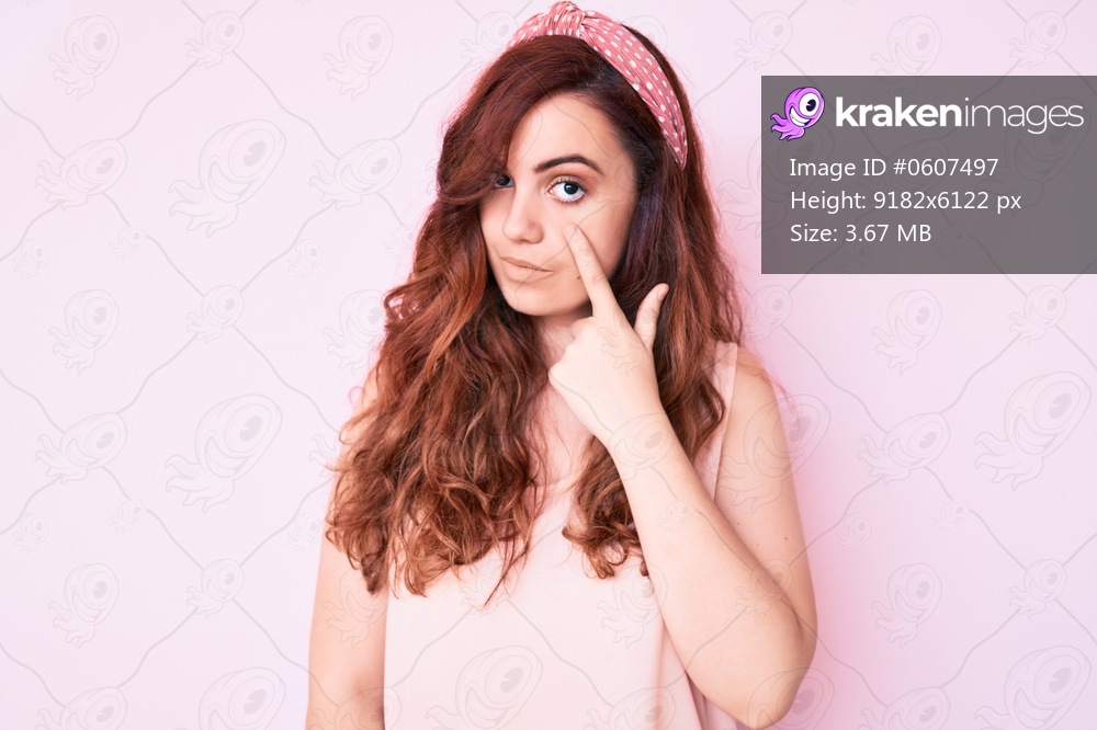 Young beautiful woman wearing casual clothes pointing to the eye watching you gesture, suspicious expression 