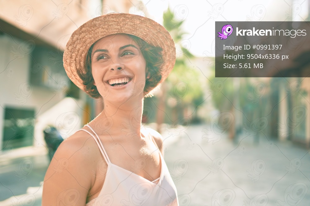 Young hispanic woman on vacation smiling happy walking at street of city