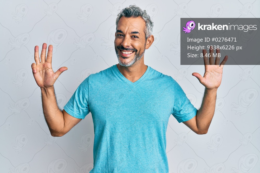 Middle age grey-haired man wearing casual clothes showing and pointing up with fingers number nine while smiling confident and happy. 