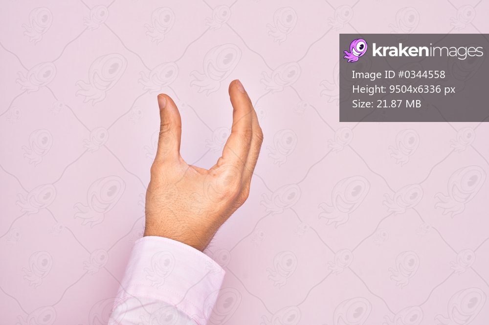 Hand of caucasian young man showing fingers over isolated pink background picking and taking invisible thing, holding object with fingers showing space