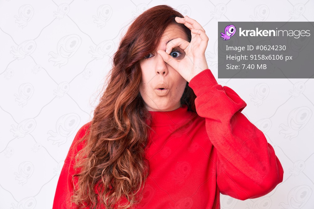 Young beautiful woman wearing casual clothes doing ok gesture shocked with surprised face, eye looking through fingers. unbelieving expression. 