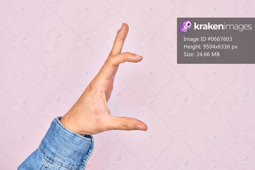 Hand of caucasian young man showing fingers over isolated pink background picking and taking invisible thing, holding object with fingers showing space