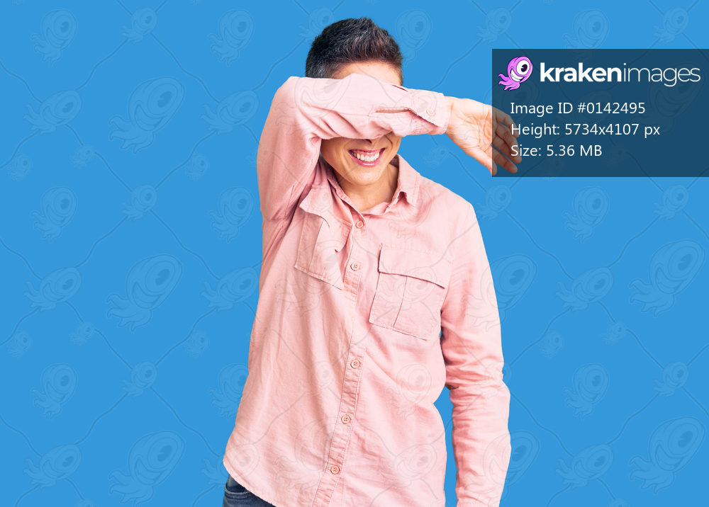 Young woman with short hair wearing casual clothes covering eyes with arm smiling cheerful and funny. blind concept. 