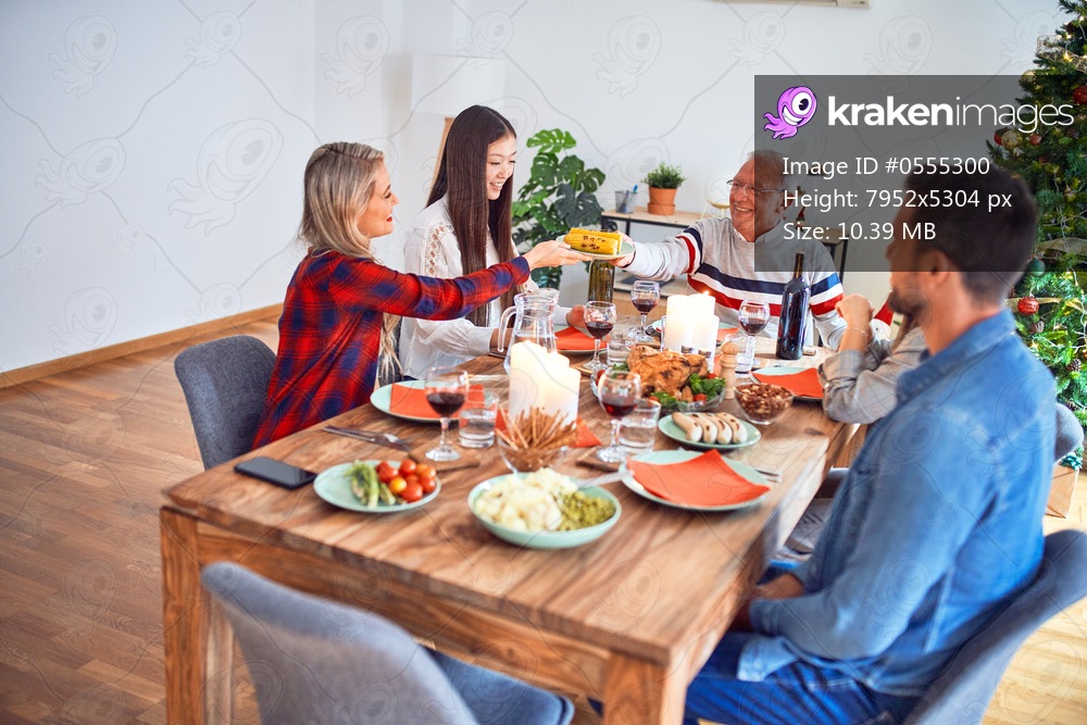 Beautiful family meeting smiling happy and confident. Eating roasted turkey celebrating Christmas at home