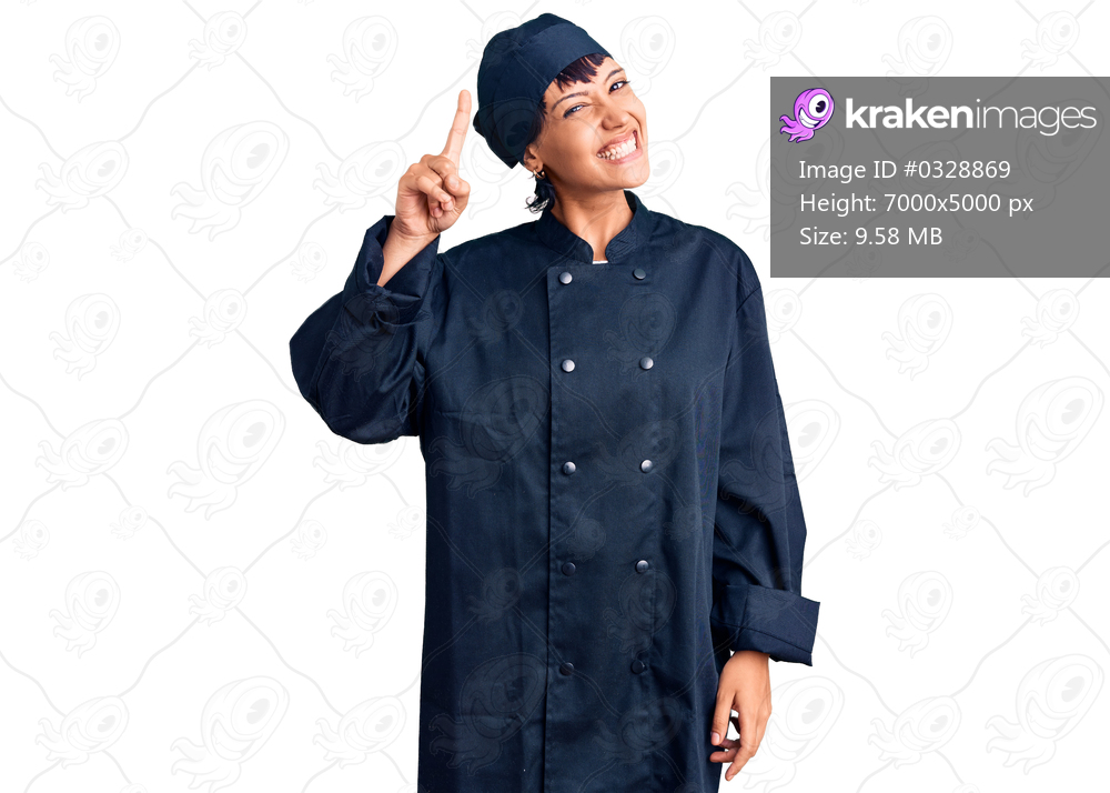 Young brunette woman with short hair wearing professional cook uniform pointing finger up with successful idea. exited and happy. number one. 