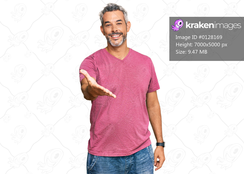 Middle age grey-haired man wearing casual clothes smiling cheerful offering palm hand giving assistance and acceptance. 