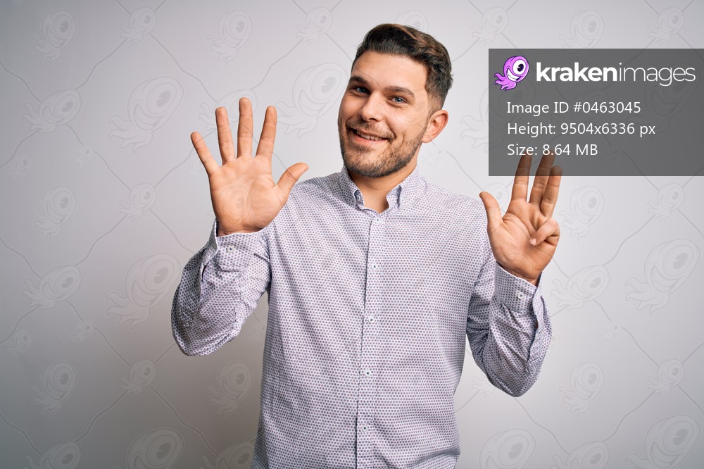 Young business man with blue eyes standing over isolated background showing and pointing up with fingers number nine while smiling confident and happy.
