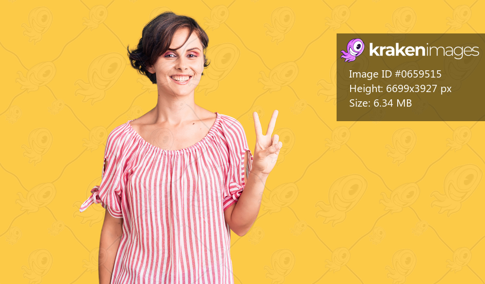 Beautiful young woman with short hair wearing casual summer clothes smiling looking to the camera showing fingers doing victory sign. number two. 