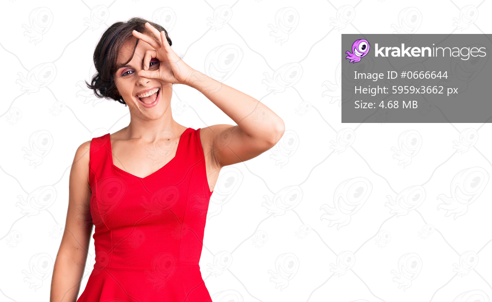 Beautiful young woman with short hair wearing casual style with sleeveless shirt doing ok gesture with hand smiling, eye looking through fingers with happy face. 