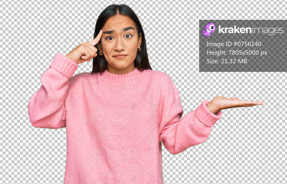Young asian woman wearing casual winter sweater confused and annoyed with open palm showing copy space and pointing finger to forehead. think about it.