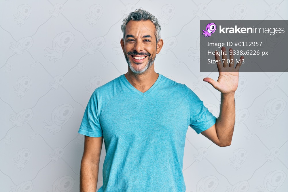 Middle age grey-haired man wearing casual clothes showing and pointing up with fingers number five while smiling confident and happy. 