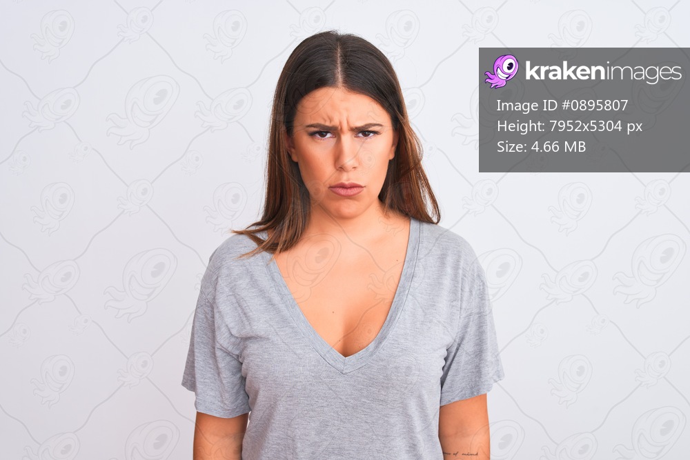 Portrait of beautiful young woman standing over isolated white background skeptic and nervous, frowning upset because of problem. Negative person.