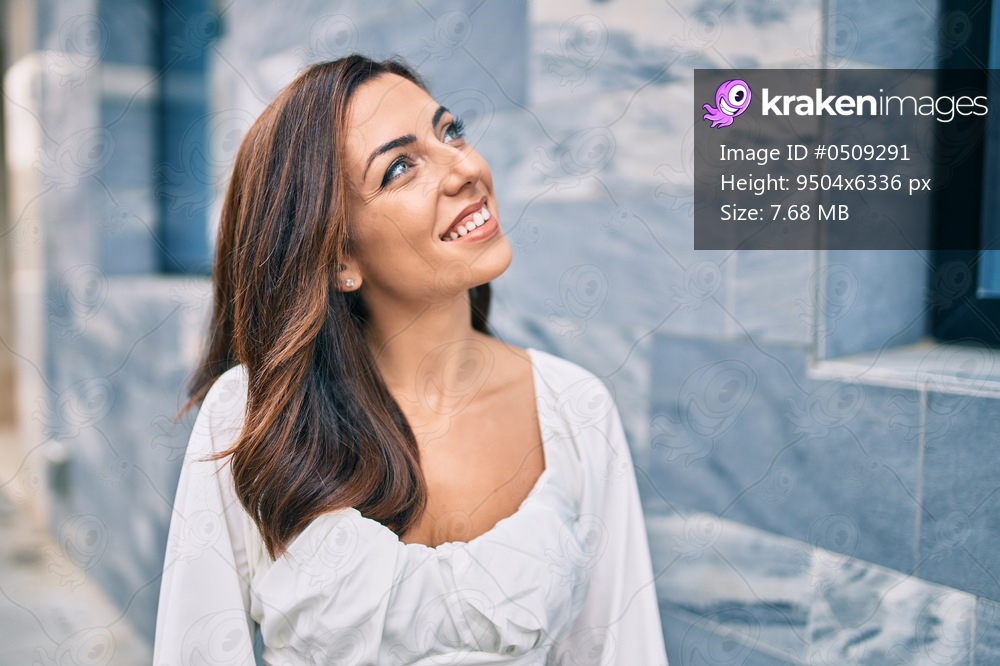 Young hispanic woman smiling happy walking at the city.