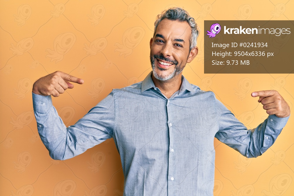 Middle age grey-haired man wearing casual clothes looking confident with smile on face, pointing oneself with fingers proud and happy. 