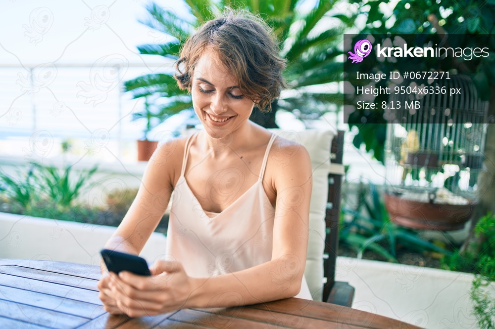 Young beautiful caucasian woman smiling happy using smartphone at home