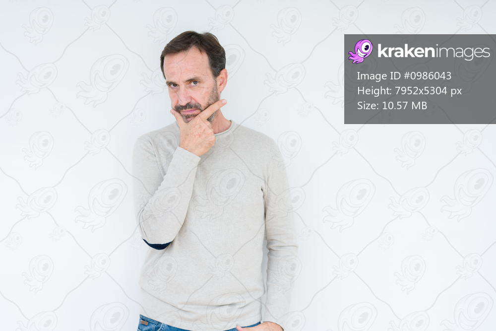 Elegant senior man over isolated background looking confident at the camera with smile with crossed arms and hand raised on chin. Thinking positive.