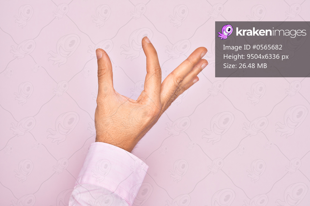 Hand of caucasian young man showing fingers over isolated pink background picking and taking invisible thing, holding object with fingers showing space