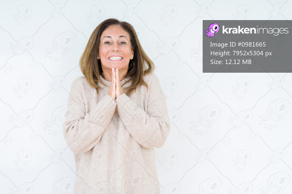 Beautiful middle age woman over isolated background praying with hands together asking for forgiveness smiling confident.