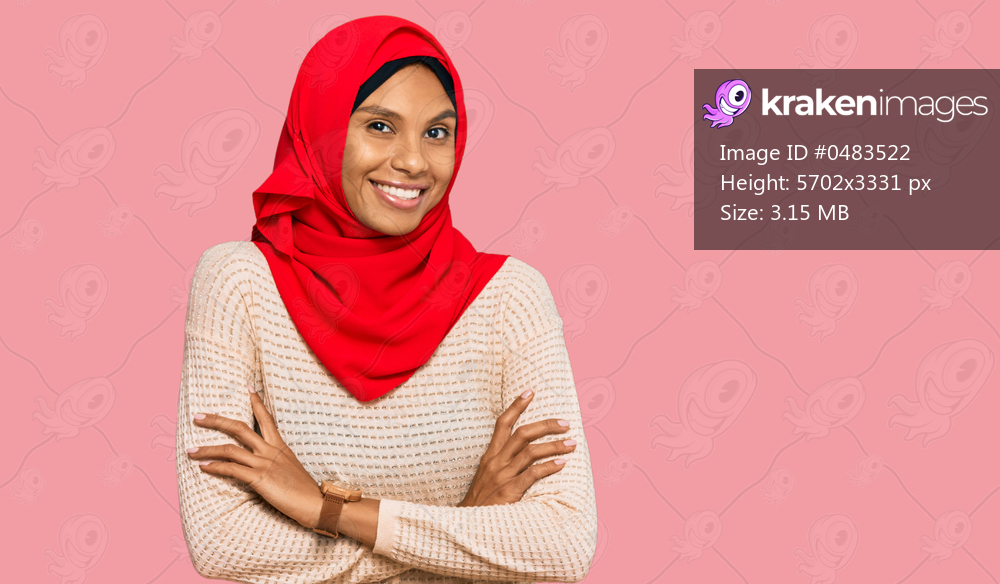Young african american woman wearing traditional islamic hijab scarf happy face smiling with crossed arms looking at the camera. positive person. 
