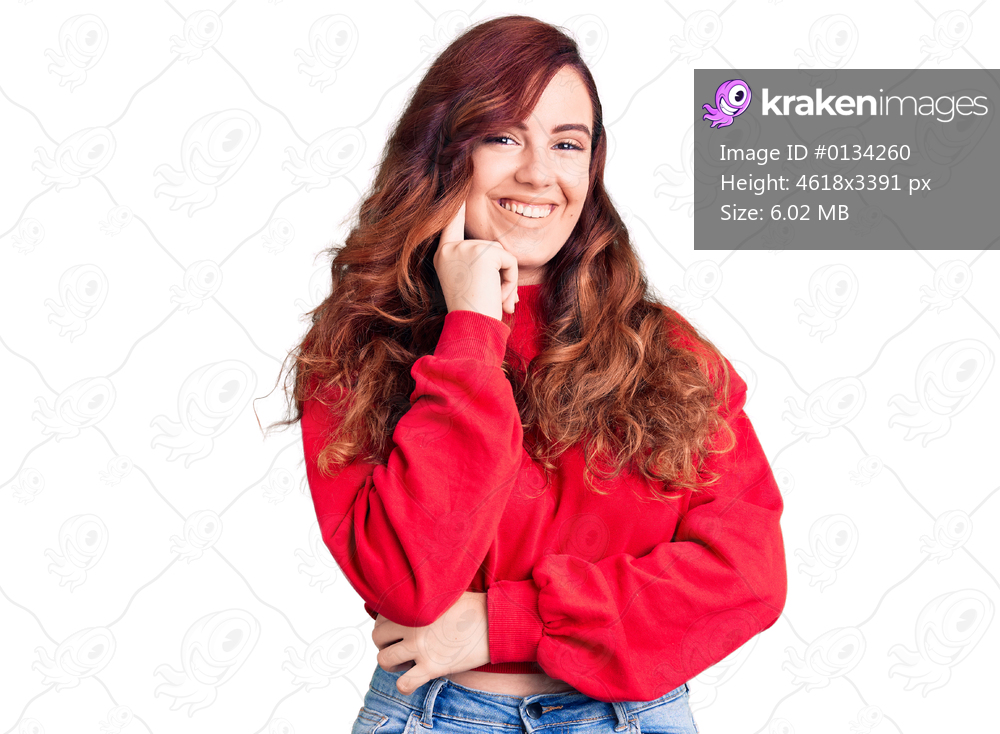 Young beautiful woman wearing casual winter sweater looking confident at the camera with smile with crossed arms and hand raised on chin. thinking positive. 
