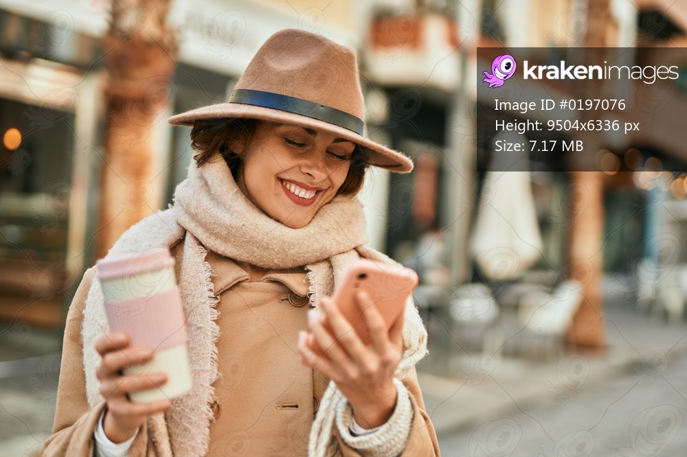 Young hispanic woman using smartphone and drinking coffee at the city.