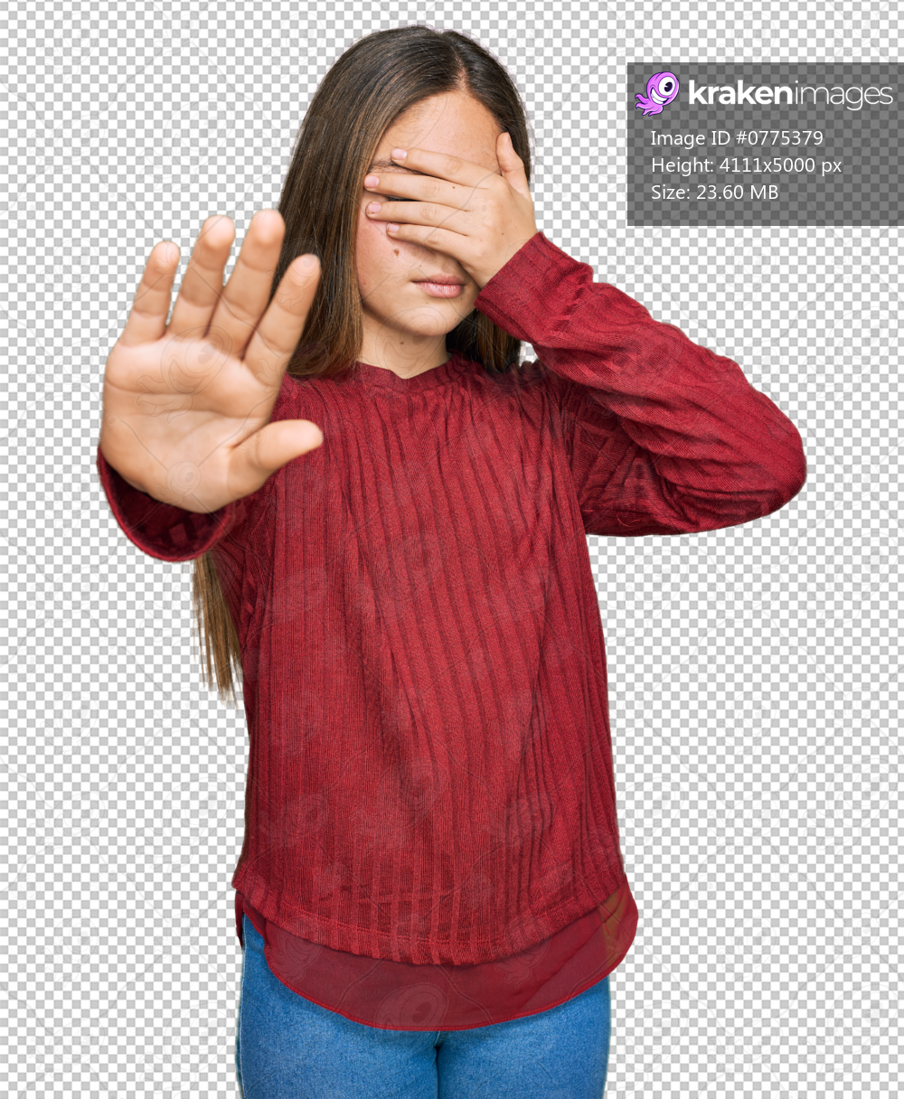 Beautiful brunette little girl wearing casual sweater covering eyes with hands and doing stop gesture with sad and fear expression. embarrassed and negative concept.