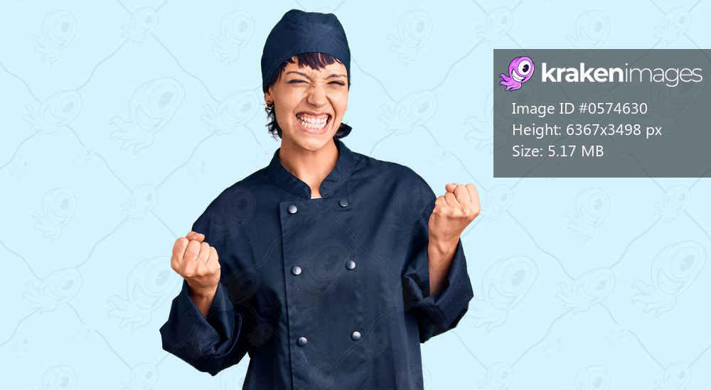 Young brunette woman with short hair wearing professional cook uniform excited for success with arms raised and eyes closed celebrating victory smiling. winner concept. 