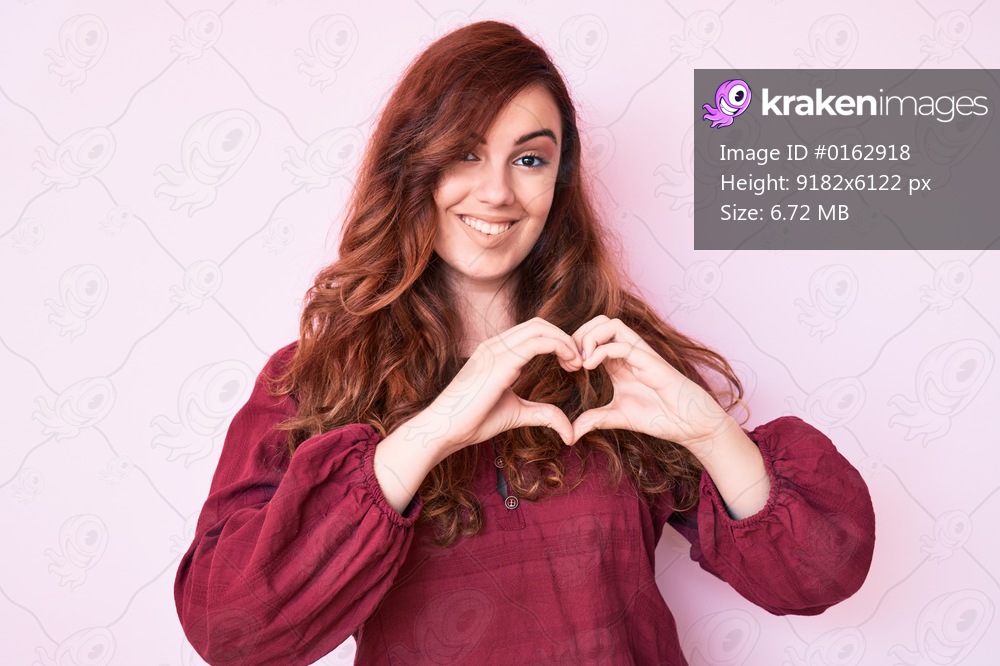 Young beautiful woman wearing casual winter sweater smiling in love showing heart symbol and shape with hands. romantic concept. 