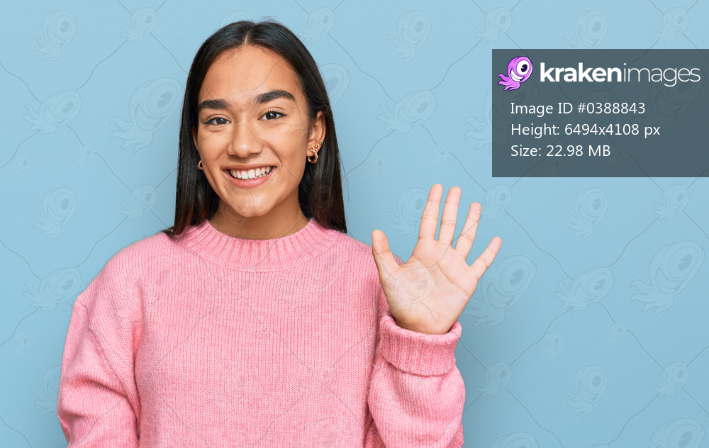 Young asian woman wearing casual winter sweater showing and pointing up with fingers number five while smiling confident and happy. 