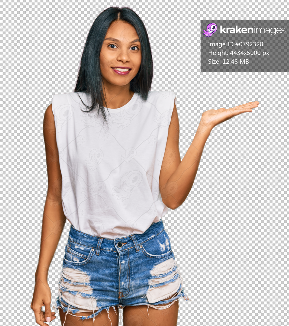 Young african american woman wearing casual clothes smiling cheerful presenting and pointing with palm of hand looking at the camera.