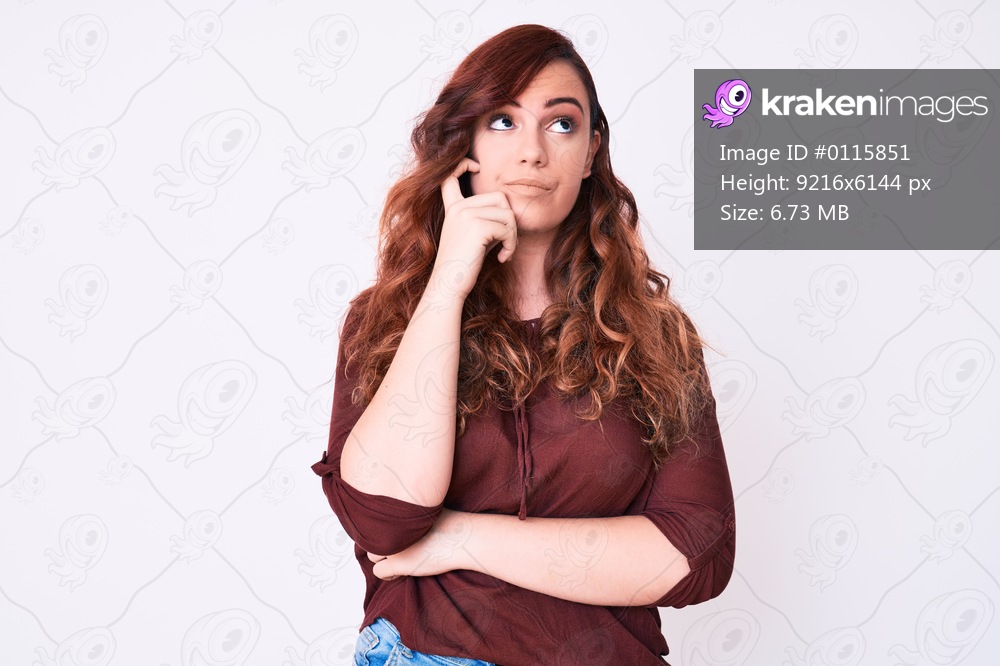 Young beautiful woman wearing casual clothes serious face thinking about question with hand on chin, thoughtful about confusing idea 