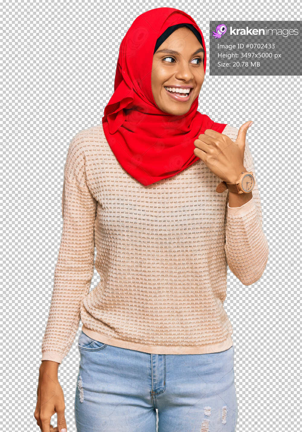 Young african american woman wearing traditional islamic hijab scarf smiling with happy face looking and pointing to the side with thumb up.