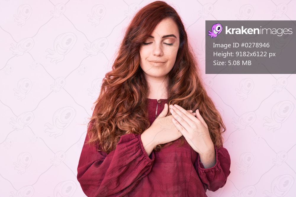 Young beautiful woman wearing casual winter sweater smiling with hands on chest with closed eyes and grateful gesture on face. health concept. 