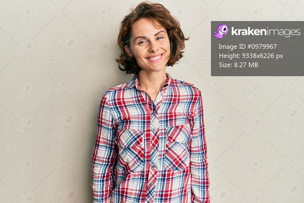 Young brunette woman wearing casual clothes with a happy and cool smile on face. lucky person. 