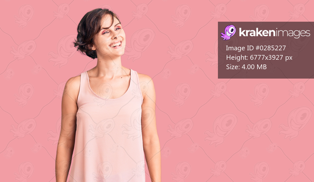 Beautiful young woman with short hair wearing casual style with sleeveless shirt looking away to side with smile on face, natural expression. laughing confident. 