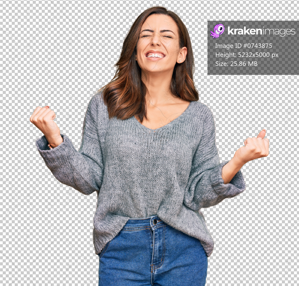 Young brunette woman wearing casual winter sweater very happy and excited doing winner gesture with arms raised, smiling and screaming for success. celebration concept.
