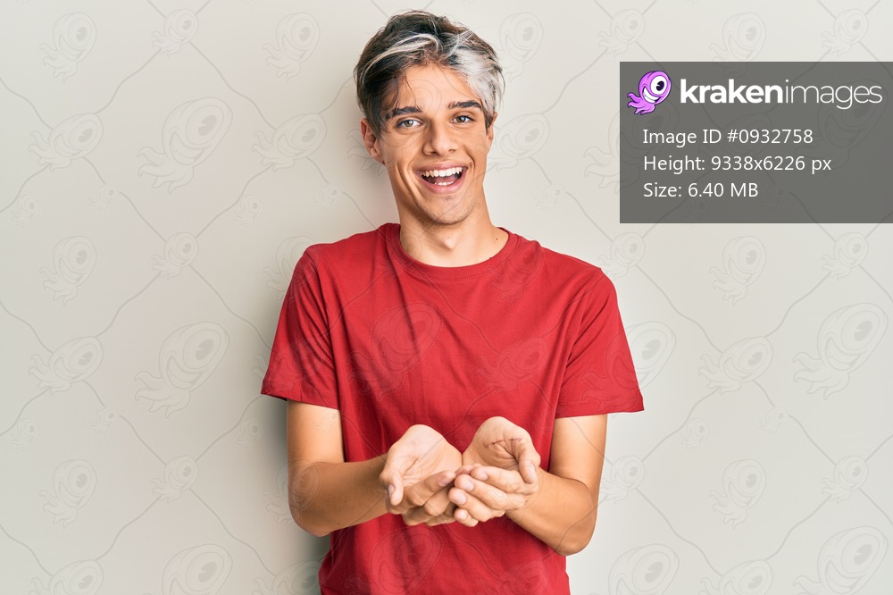 Young hispanic man wearing casual clothes smiling with hands palms together receiving or giving gesture. hold and protection 