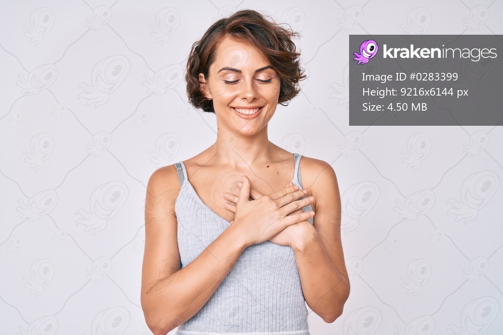 Young hispanic woman wearing casual clothes smiling with hands on chest with closed eyes and grateful gesture on face. health concept. 