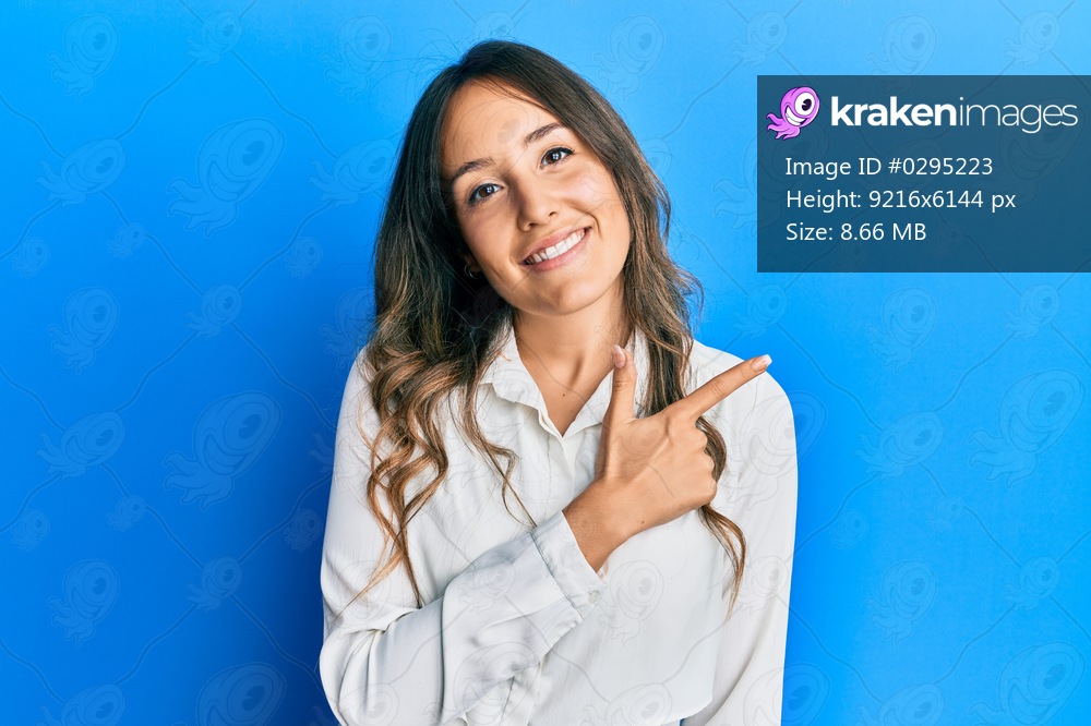 Young brunette woman wearing casual clothes smiling cheerful pointing with hand and finger up to the side 