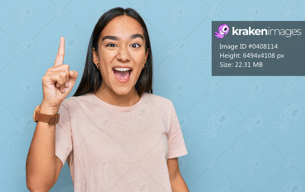 Young asian woman wearing casual clothes pointing finger up with successful idea. exited and happy. number one. 