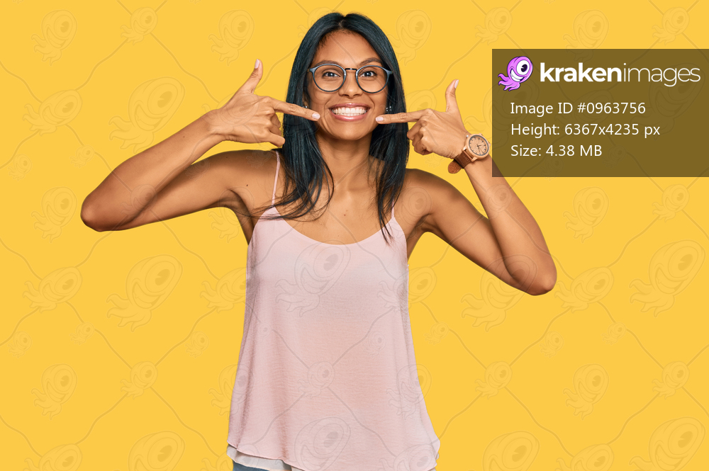 Young african american woman wearing casual clothes and glasses smiling cheerful showing and pointing with fingers teeth and mouth. dental health concept. 