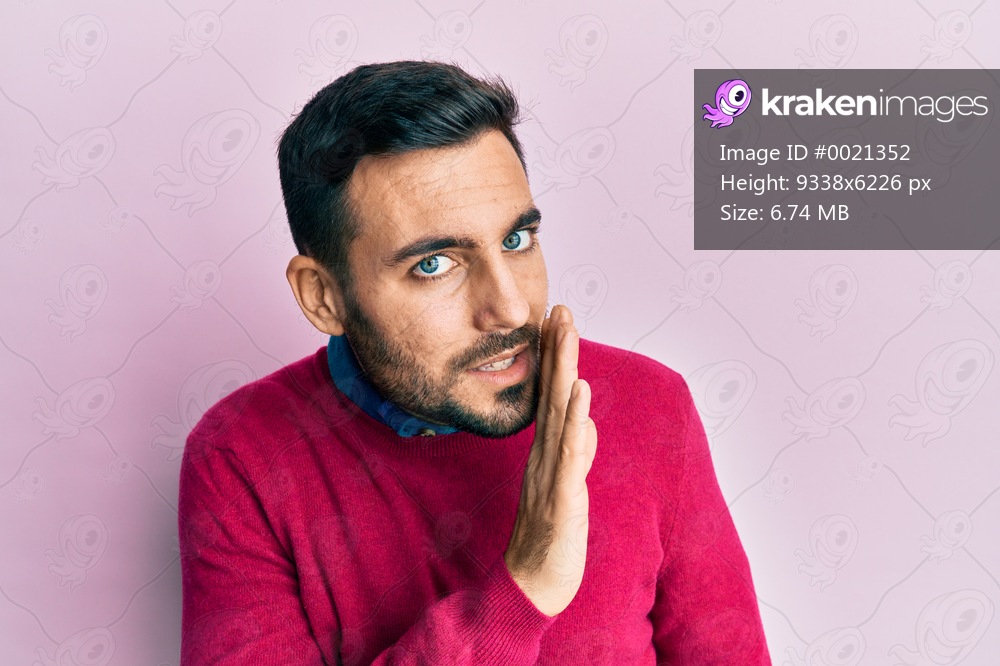 Young hispanic man wearing casual clothes hand on mouth telling secret rumor, whispering malicious talk conversation 