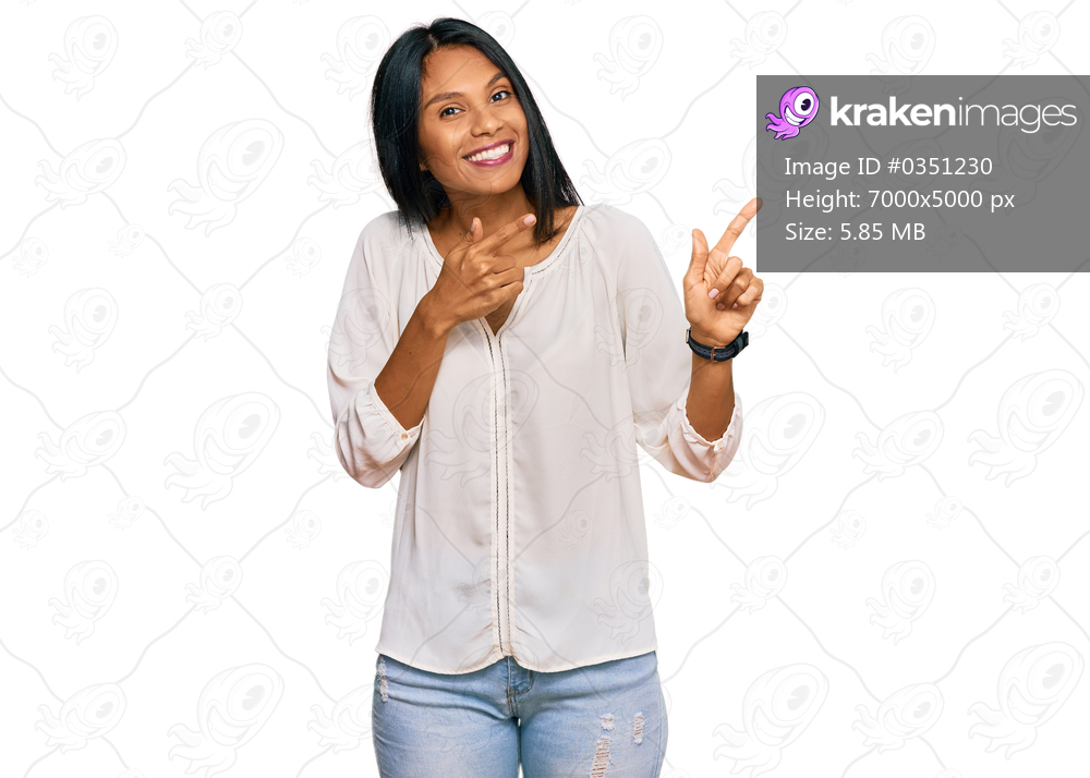 Young african american woman wearing casual clothes smiling and looking at the camera pointing with two hands and fingers to the side. 